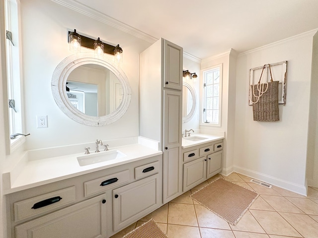 bathroom with visible vents, baseboards, ornamental molding, vanity, and tile patterned flooring