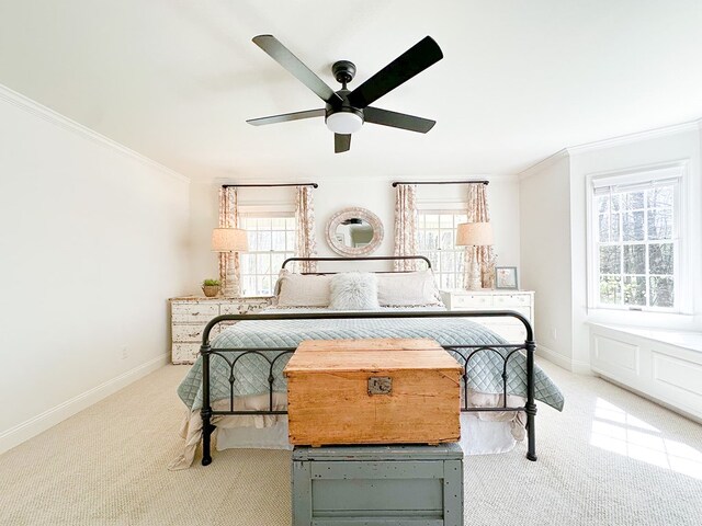 bedroom featuring ornamental molding, baseboards, multiple windows, and carpet floors