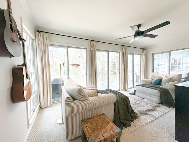 bedroom with access to exterior, light colored carpet, and crown molding