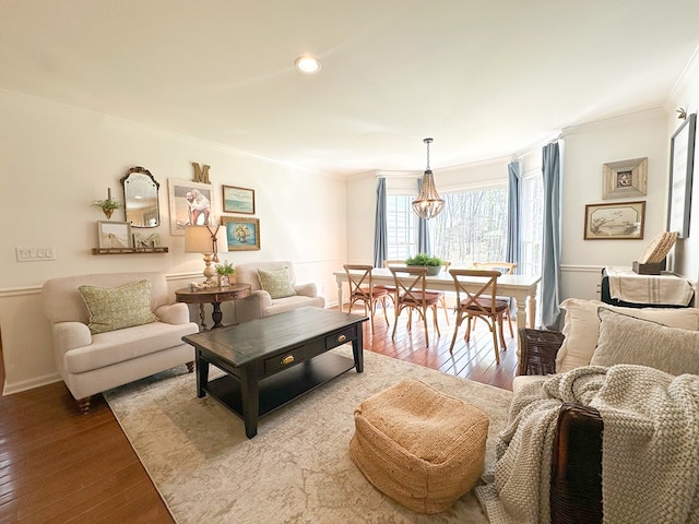 living room with crown molding and hardwood / wood-style floors