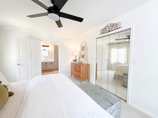 bedroom with crown molding, a closet, light colored carpet, a ceiling fan, and baseboards
