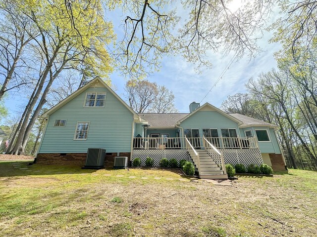 back of property featuring a yard, a deck, crawl space, and central AC