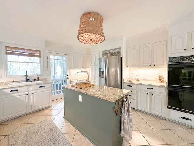 kitchen featuring a sink, stainless steel refrigerator with ice dispenser, crown molding, and dobule oven black