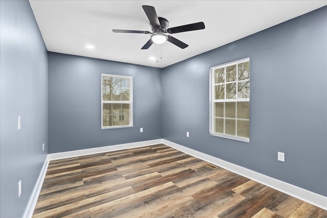 spare room featuring wood-type flooring and ceiling fan