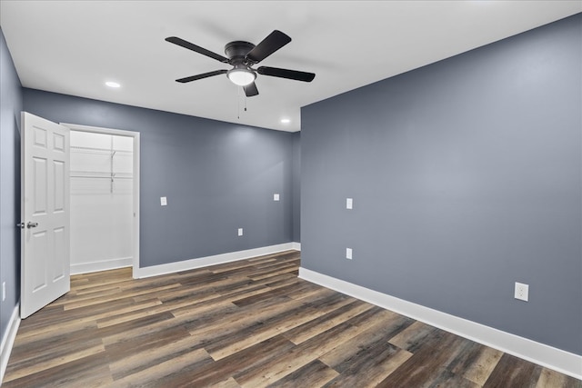 empty room with ceiling fan and dark hardwood / wood-style flooring