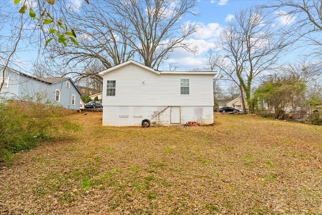 back of property with a lawn