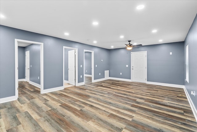 empty room with ceiling fan and dark hardwood / wood-style flooring