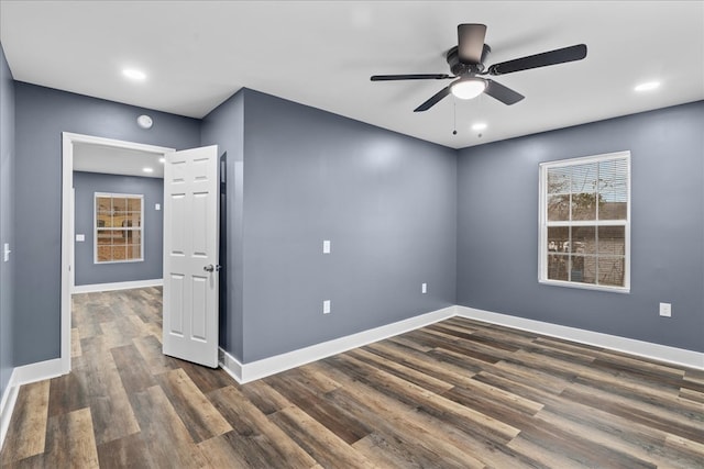 spare room with ceiling fan and dark hardwood / wood-style floors