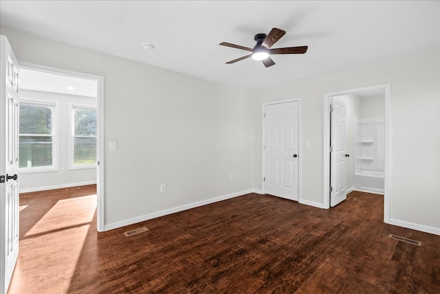 unfurnished bedroom featuring baseboards, visible vents, and wood finished floors