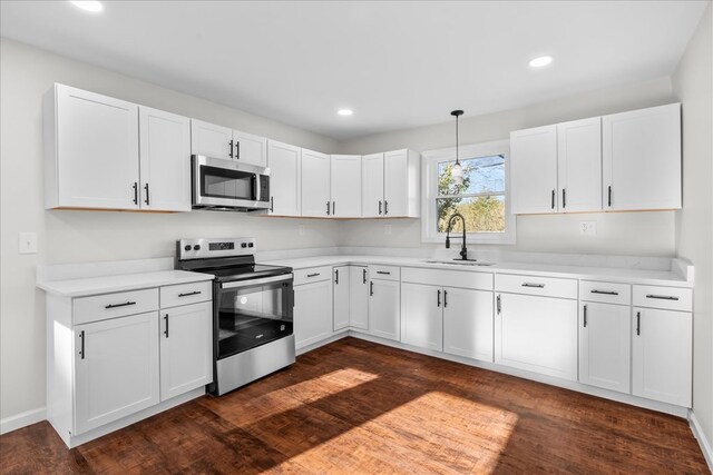 kitchen with white cabinetry, a sink, stainless steel appliances, and light countertops
