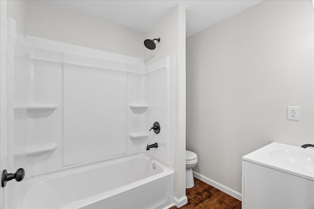 full bath featuring vanity, toilet, baseboards,  shower combination, and wood finished floors