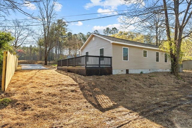 view of property exterior featuring crawl space and a deck