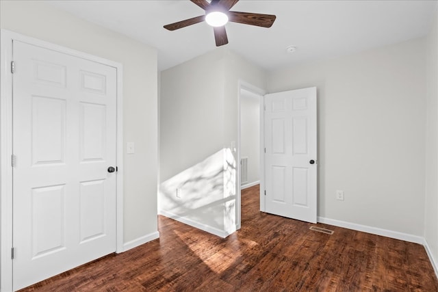 unfurnished bedroom with baseboards, visible vents, and wood finished floors