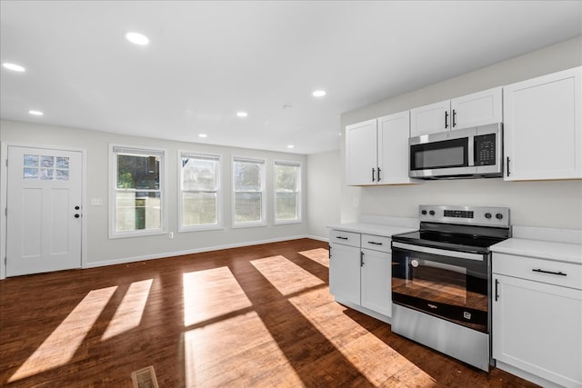 kitchen with visible vents, recessed lighting, appliances with stainless steel finishes, open floor plan, and dark wood-style floors