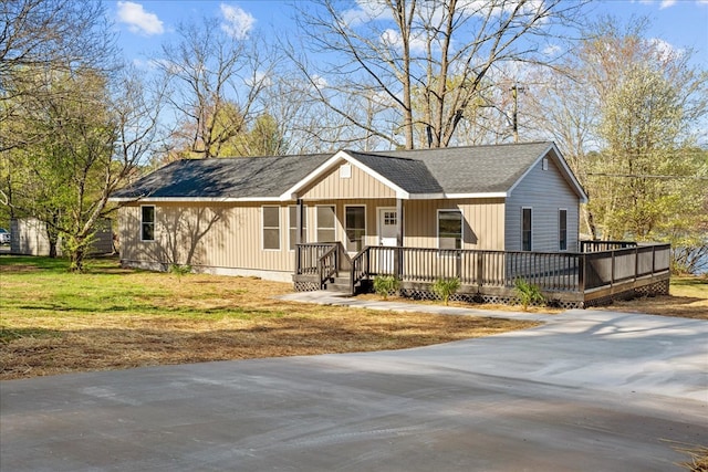 ranch-style home featuring a porch and a shingled roof