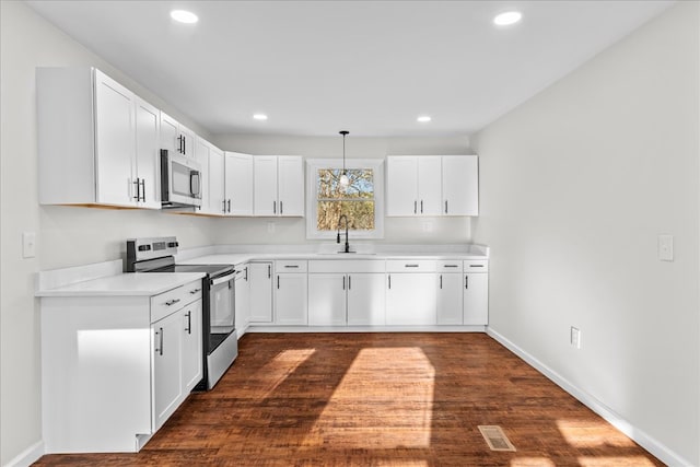 kitchen featuring white cabinetry, light countertops, a sink, and stainless steel appliances