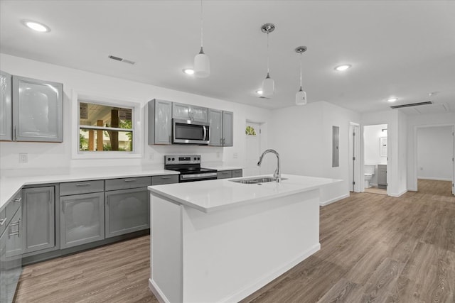 54 Austin Dr, Rossville, GA 30741 - kitchen with stainless steel appliances, gray cabinets, light wood-type flooring, light countertops, and hanging light fixtures