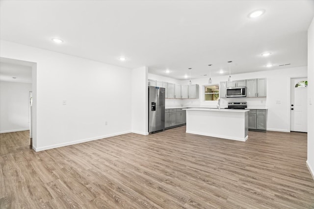 54 Austin Dr, Rossville, GA 30741 - kitchen featuring stainless steel appliances, light wood-type flooring, light countertops, open floor plan, and recessed lighting