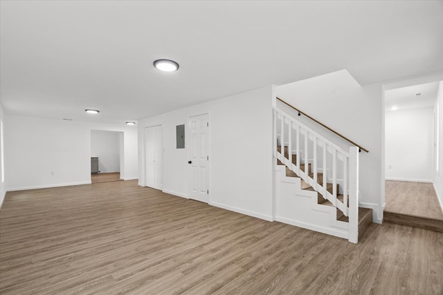 54 Austin Dr, Rossville, GA 30741 - unfurnished living room with electric panel, light wood-type flooring, and stairs