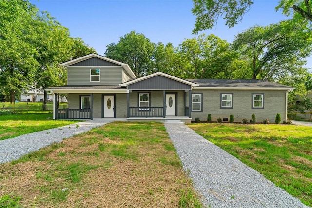 54 Austin Dr, Rossville, GA 30741 - view of front facade featuring a porch, a front yard, and brick siding