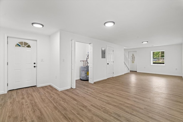 54 Austin Dr, Rossville, GA 30741 - entrance foyer featuring electric water heater, electric panel, wood finished floors, and stairs