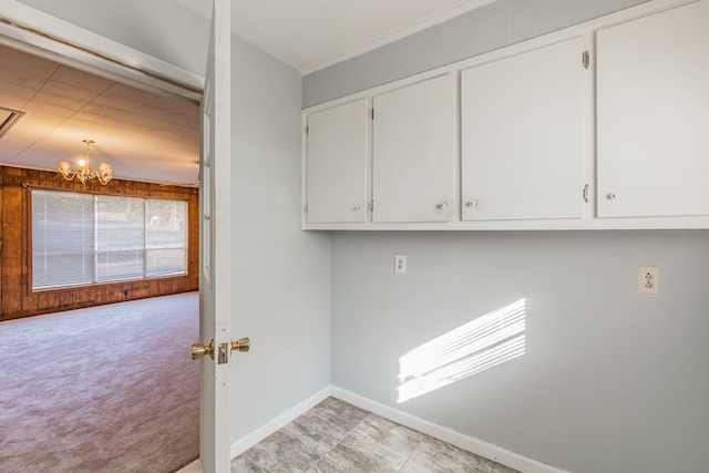 washroom with light carpet and an inviting chandelier