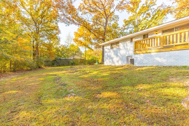 view of yard featuring a wooden deck