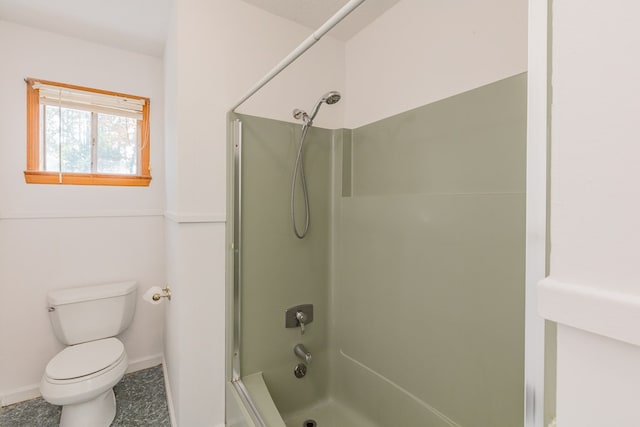 bathroom featuring shower / bathtub combination and toilet