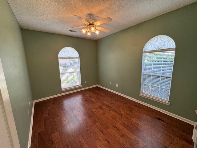 1694 Red Oak Dr Unit 185, Dalton, GA 30721 - unfurnished room with dark wood-style floors, healthy amount of natural light, ceiling fan, a textured ceiling, and baseboards