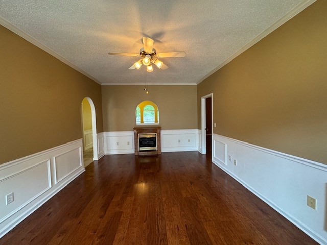 1694 Red Oak Dr Unit 185, Dalton, GA 30721 - unfurnished living room with arched walkways, ceiling fan, a textured ceiling, dark wood-style floors, and a glass covered fireplace