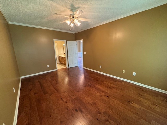 1694 Red Oak Dr Unit 185, Dalton, GA 30721 - unfurnished bedroom with dark wood-style flooring, baseboards, ensuite bath, a textured ceiling, and crown molding