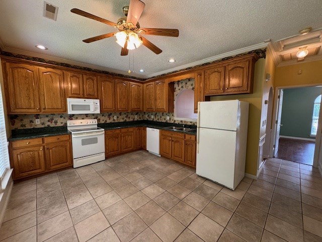 1694 Red Oak Dr Unit 185, Dalton, GA 30721 - kitchen with white appliances, crown molding, brown cabinets, light tile patterned floors, and dark countertops