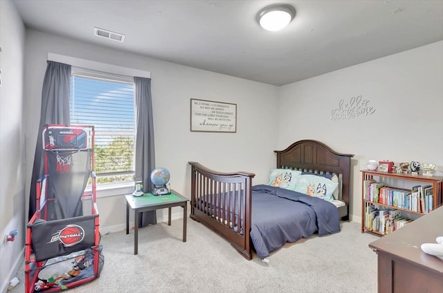 carpeted bedroom with baseboards and visible vents