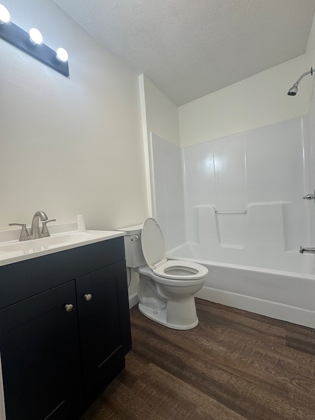 408 Ridgecrest Dr, Lafayette, GA 30728 - full bathroom featuring wood finished floors, toilet, vanity, tub / shower combination, and a textured ceiling