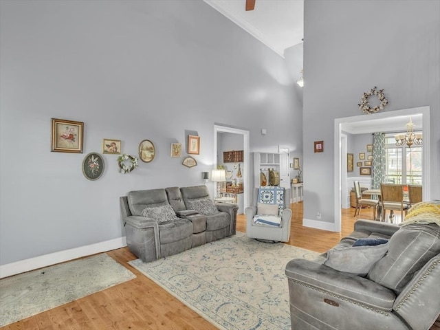 1000 Robin Way, Rocky Face, GA 30740 - living room with a chandelier, high vaulted ceiling, baseboards, wood finished floors, and crown molding