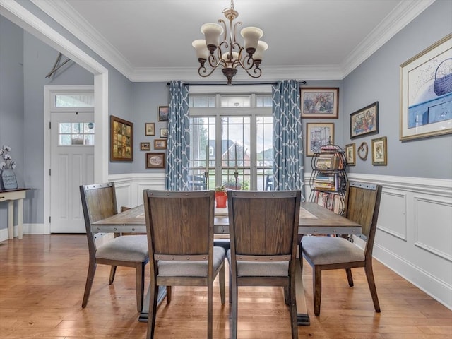 1000 Robin Way, Rocky Face, GA 30740 - dining space featuring a chandelier, crown molding, light wood-type flooring, a wainscoted wall, and a decorative wall