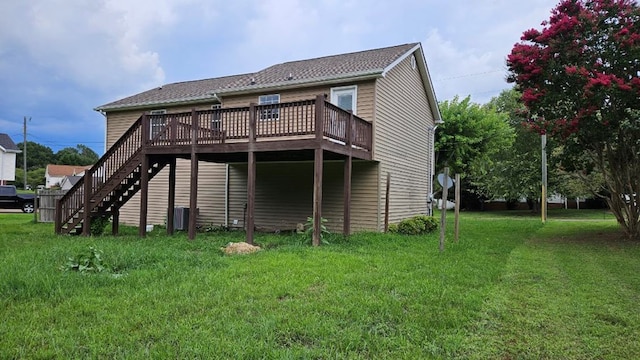 back of property with a wooden deck and a yard