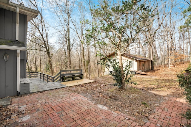 exterior space with a wooden deck and a storage shed