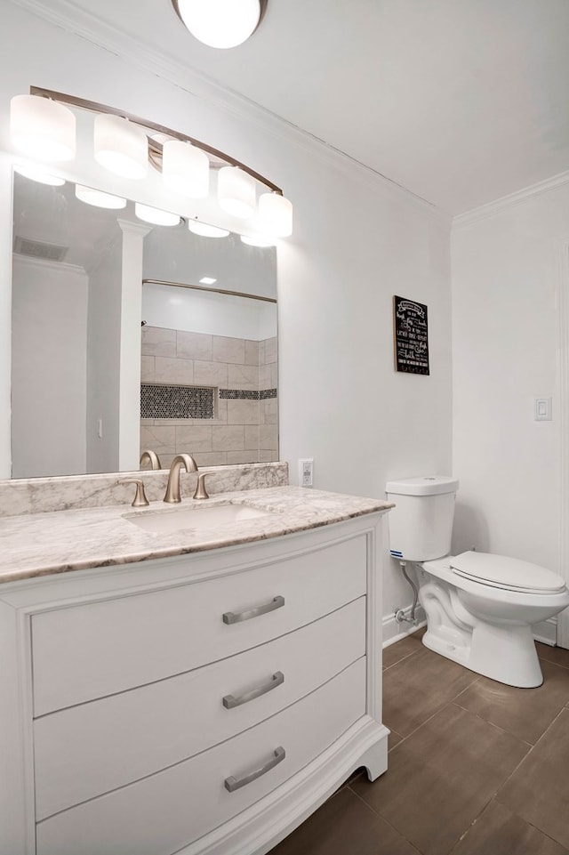 bathroom with ornamental molding, a shower, vanity, and toilet