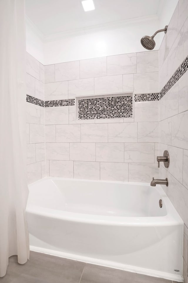 bathroom featuring ornamental molding and shower / bath combo with shower curtain