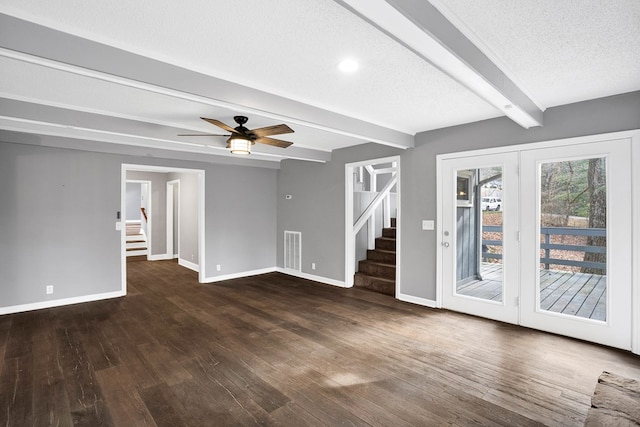 unfurnished living room featuring ceiling fan, a textured ceiling, dark wood-type flooring, and beamed ceiling