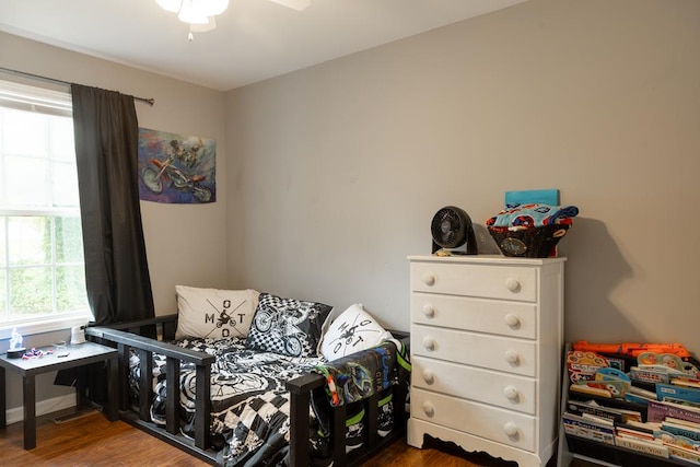 bedroom with ceiling fan and dark hardwood / wood-style flooring