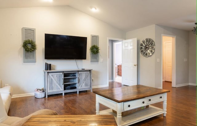 living room featuring dark hardwood / wood-style flooring and vaulted ceiling