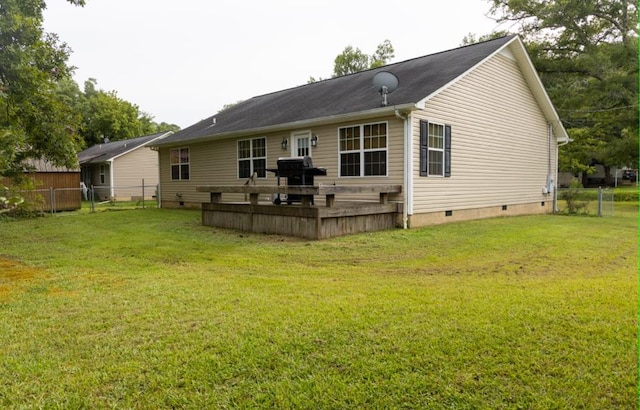 back of property featuring a lawn