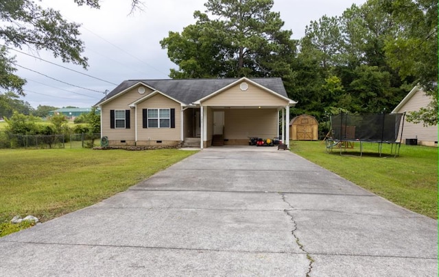 view of front of property featuring a storage shed, a front lawn, and a carport