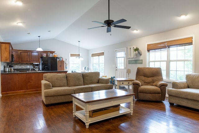 living room with ceiling fan, dark hardwood / wood-style floors, vaulted ceiling, and a wealth of natural light