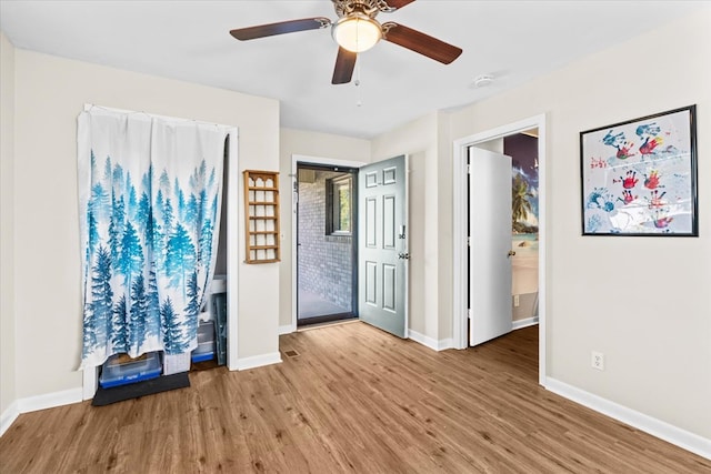 entrance foyer with ceiling fan and light hardwood / wood-style floors