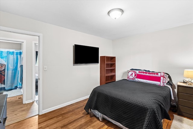 bedroom with hardwood / wood-style flooring