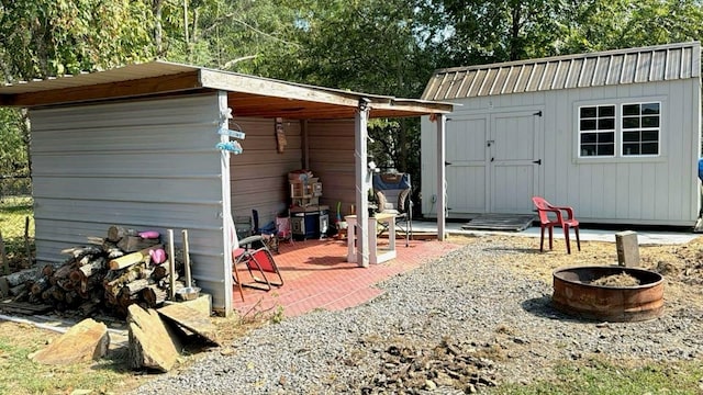 view of outbuilding featuring a fire pit