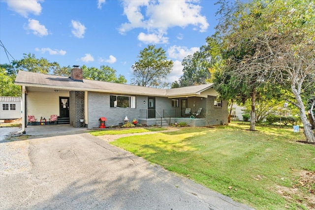 ranch-style home with a carport and a front yard